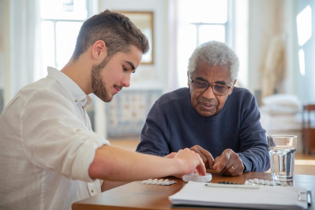 Care service provider assisting an elderly man