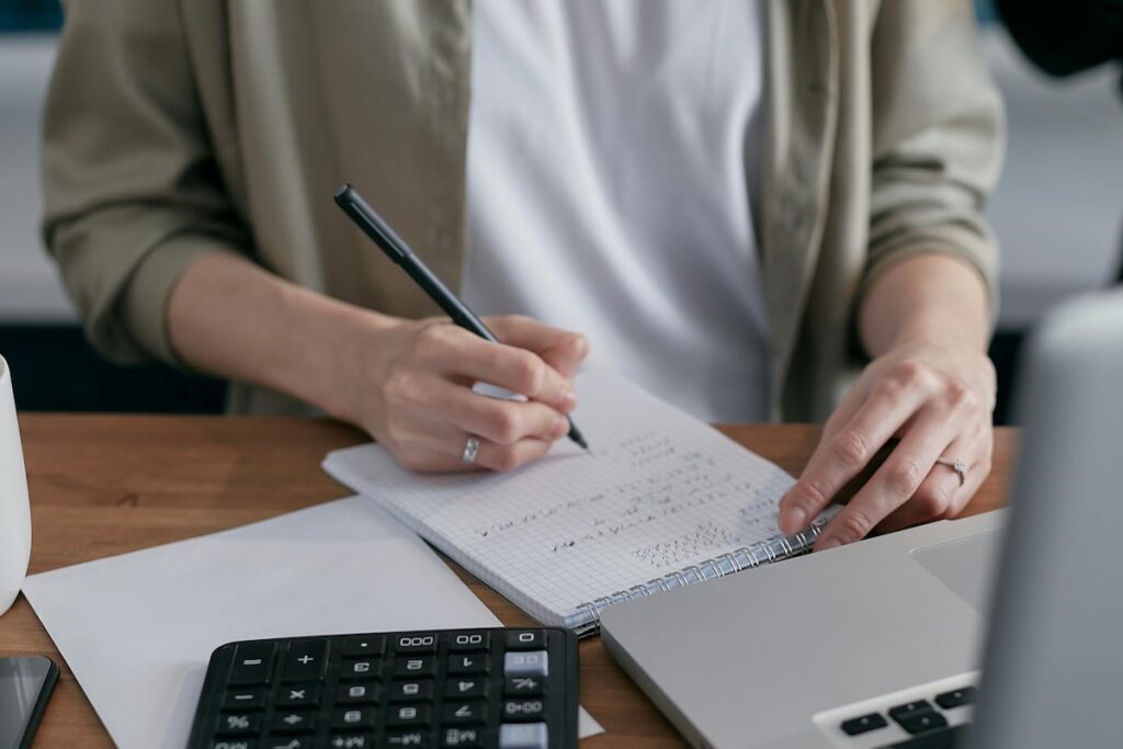 A person calculating balances on invoice