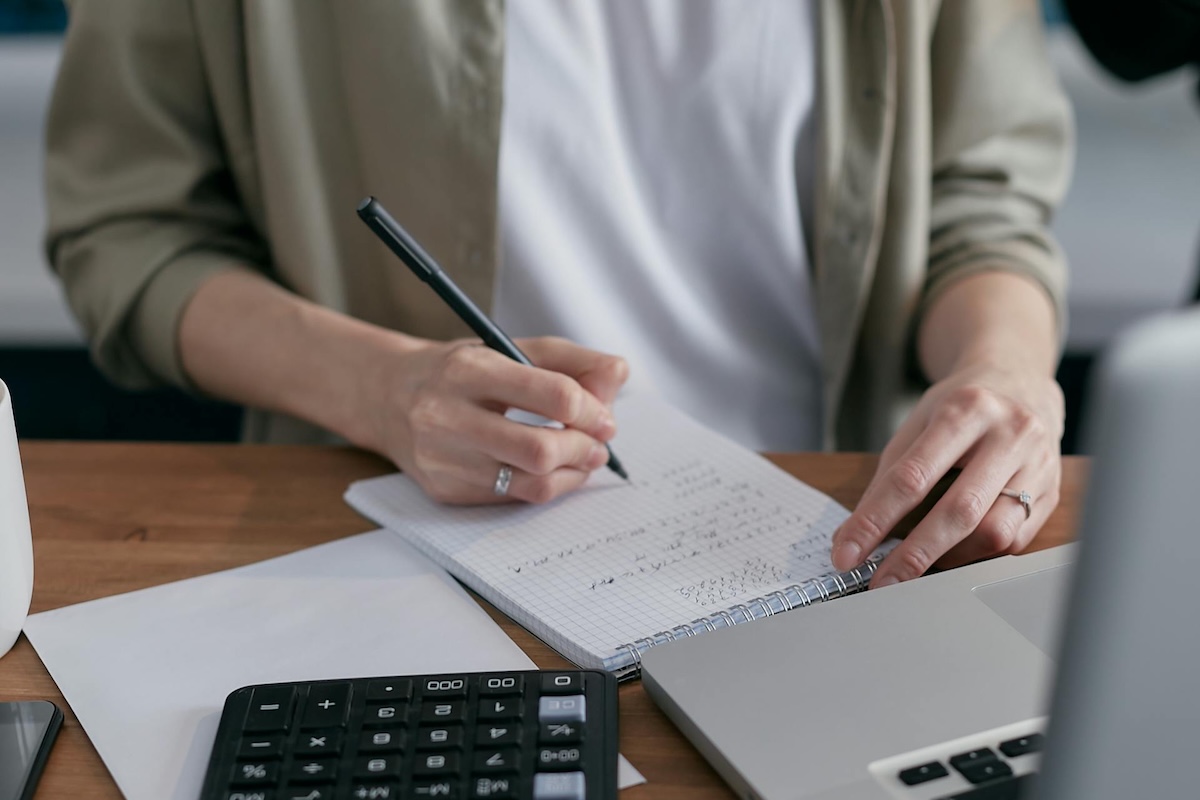 A person calculating balances on invoice