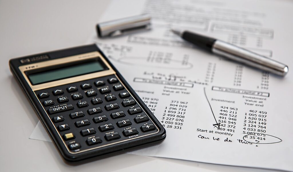 Calculator and balance sheets together on top of each other