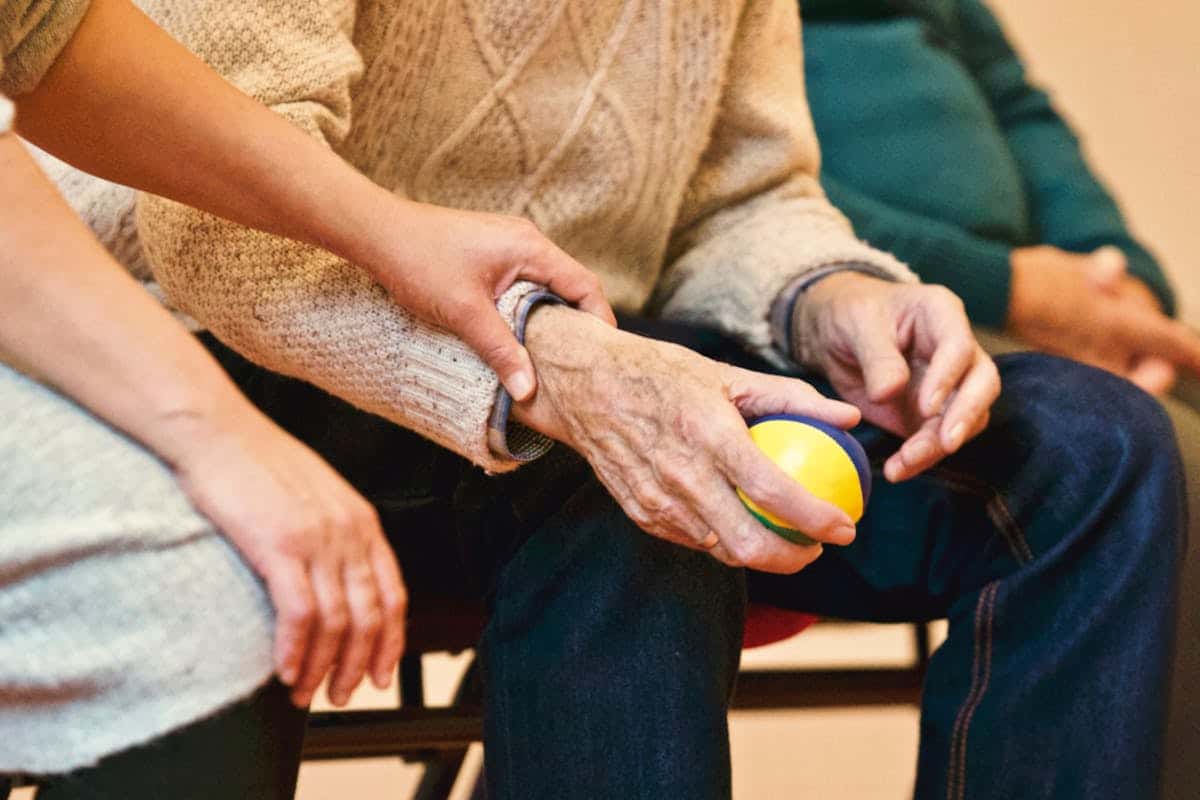 A young person's hands on top of an older person's hands