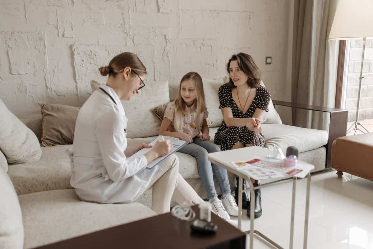 Mother and daughter consulting with a medical professional