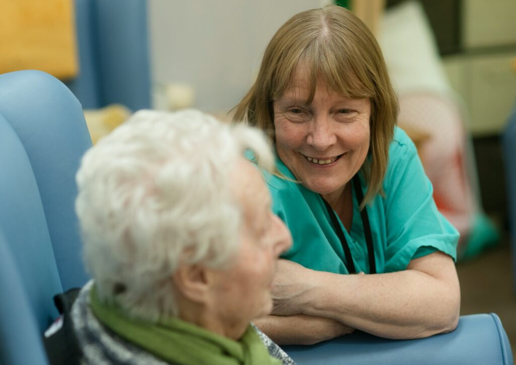 Carer laughing and smiling with her older participant