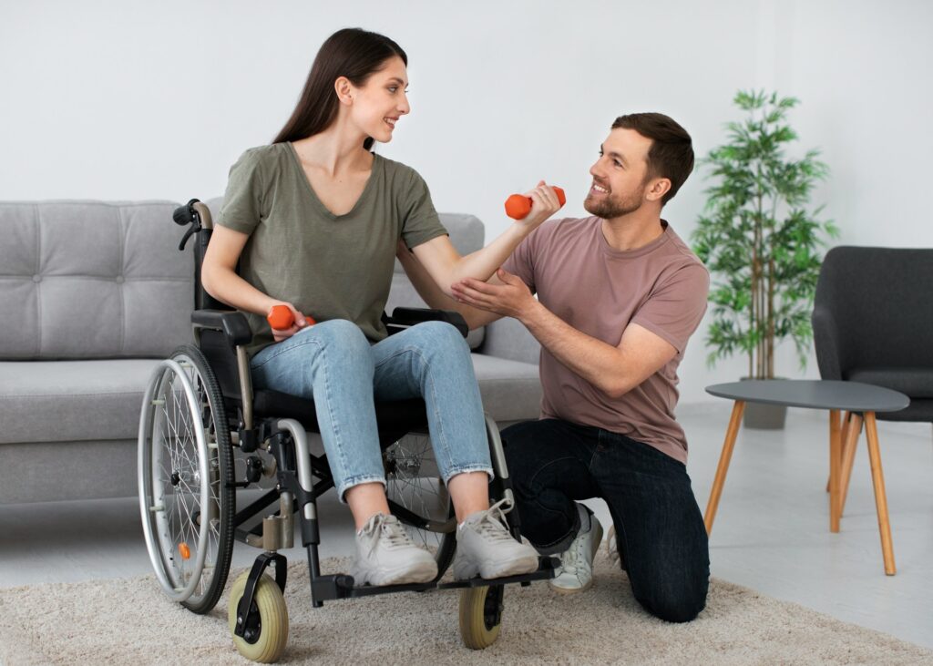 Carer in brown shirt assisting wheelchair user