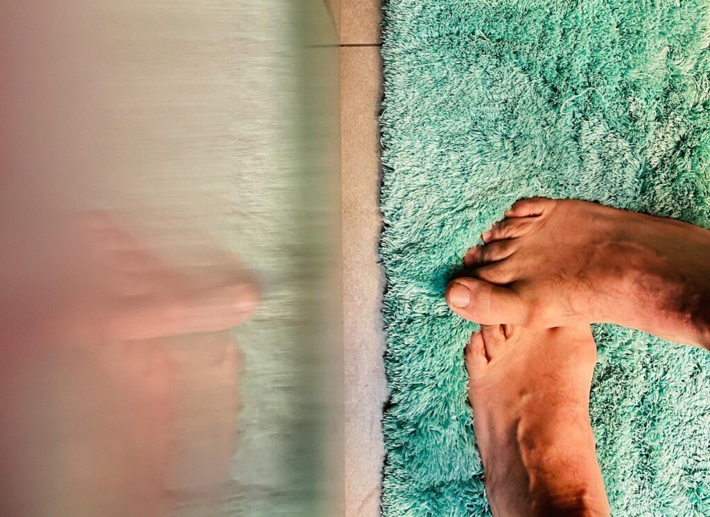 Bare feet on a rug in the bathroom