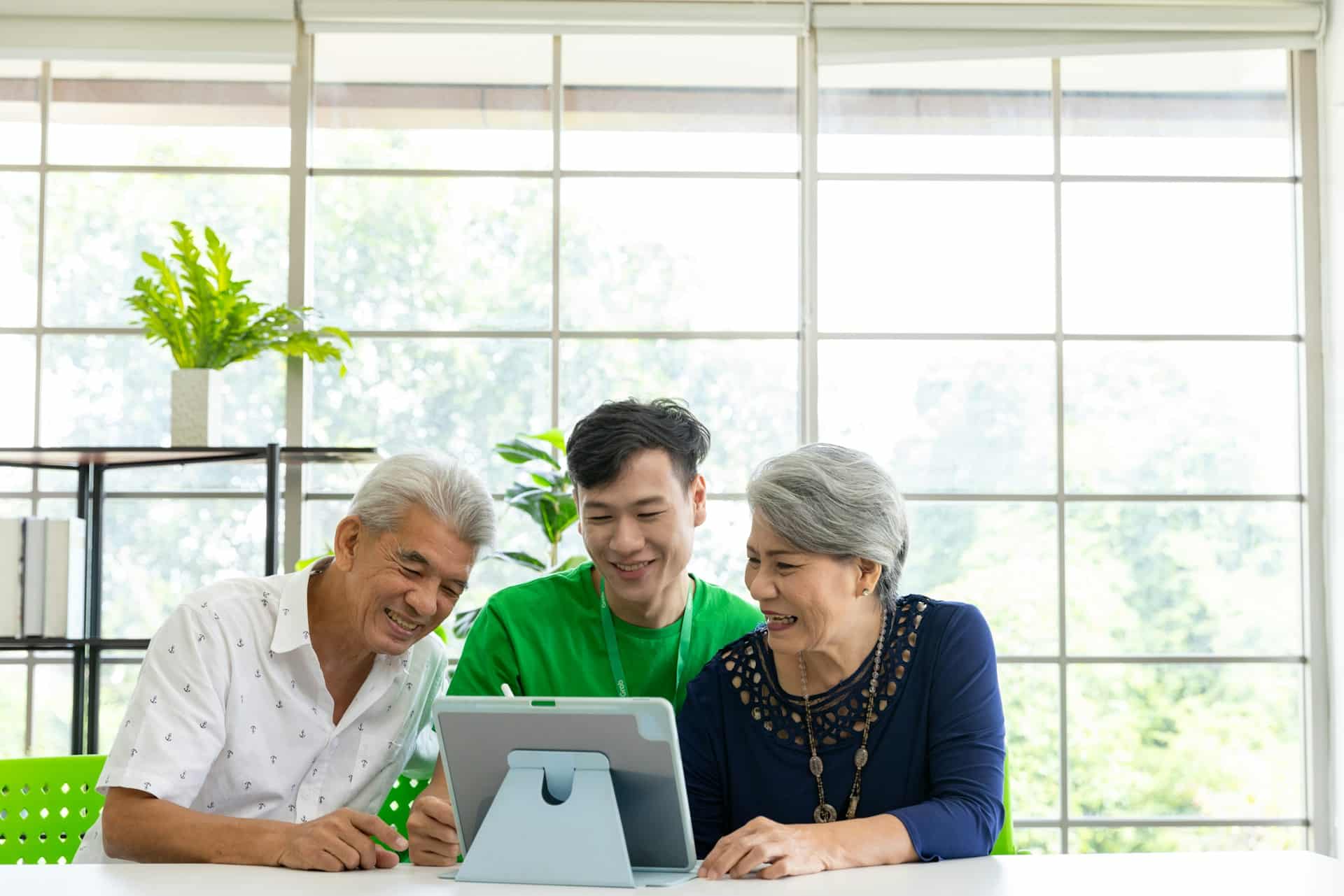 One young carer and two seniors using computer