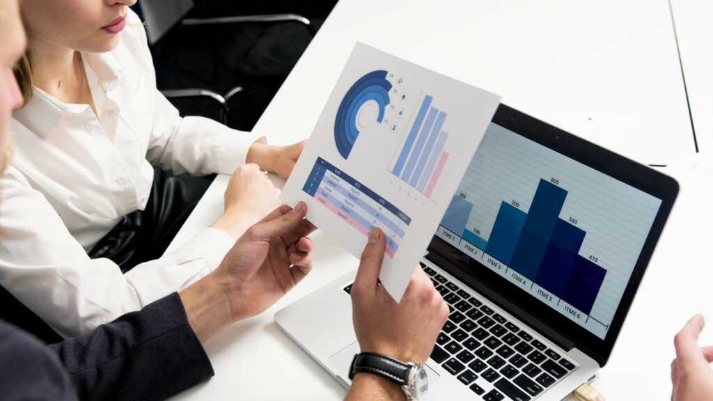 Two professionals looking at a spreadsheet
