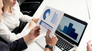 Two professionals looking at a spreadsheet