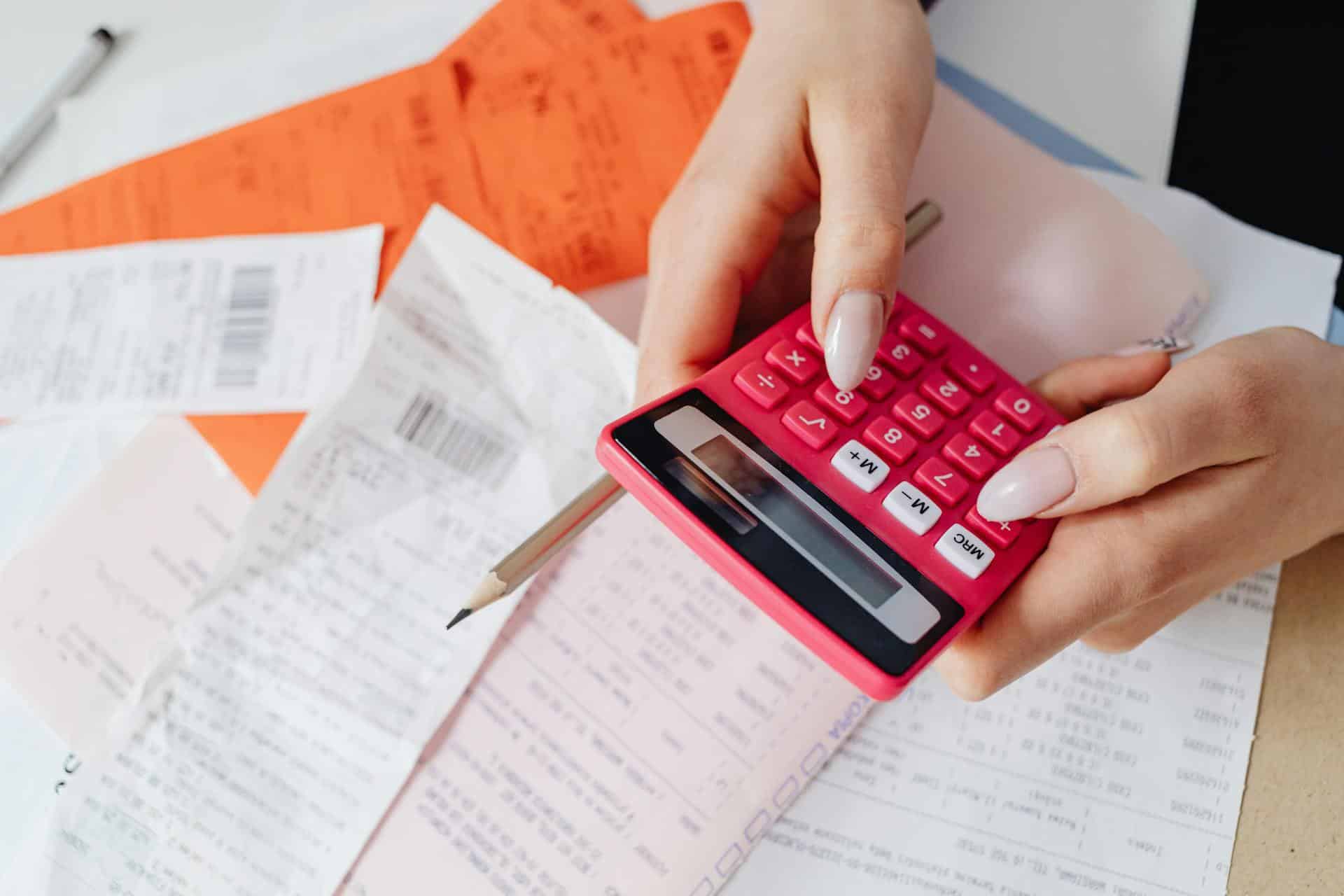 Person using a calculator on top some sheets