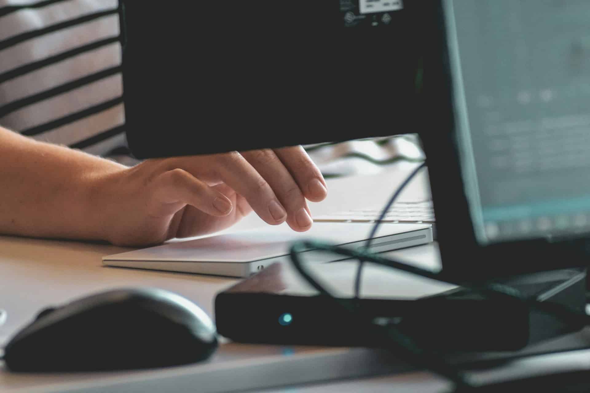 Hands of a person using a computer