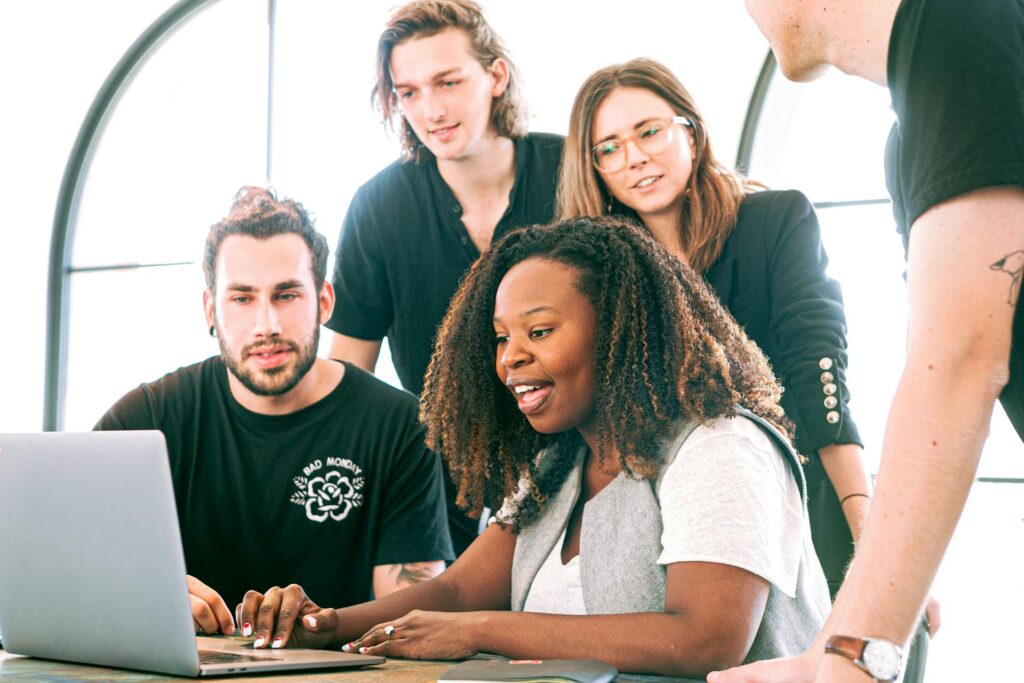 Group of workers collaborating on a laptop
