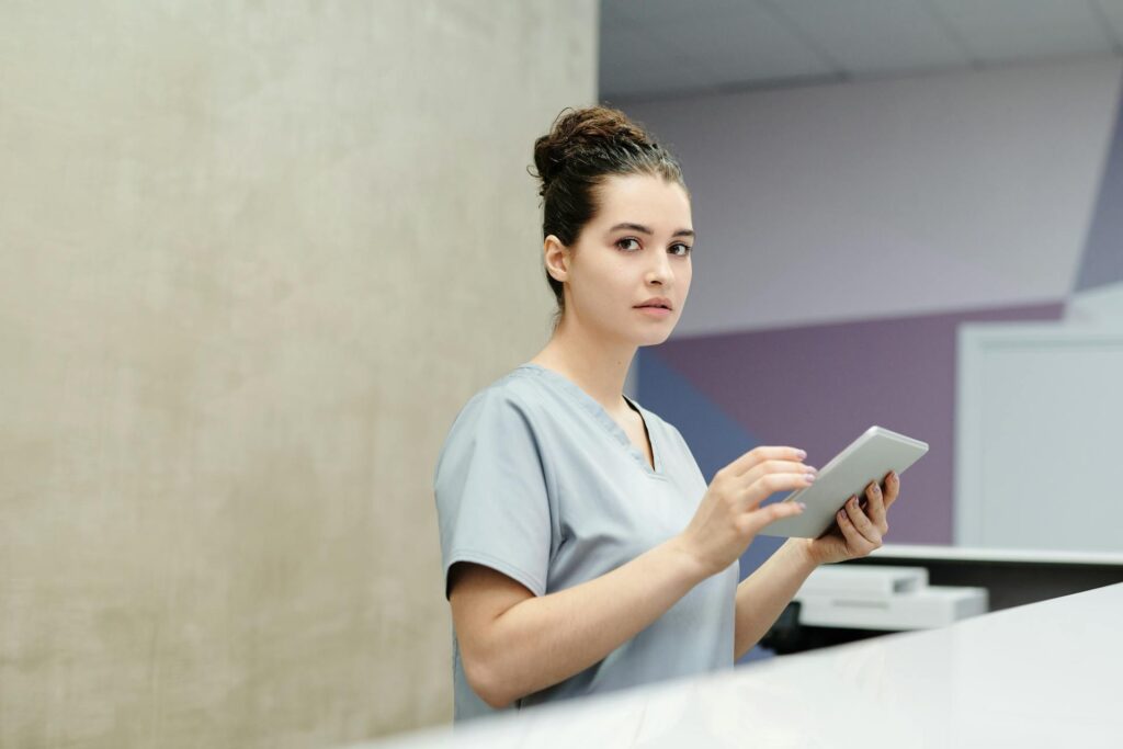 Carer holding a notebook at the counter