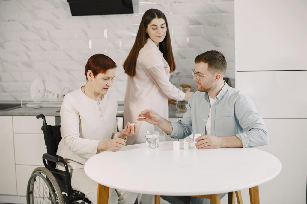 Two carers assisting a female wheelchair user