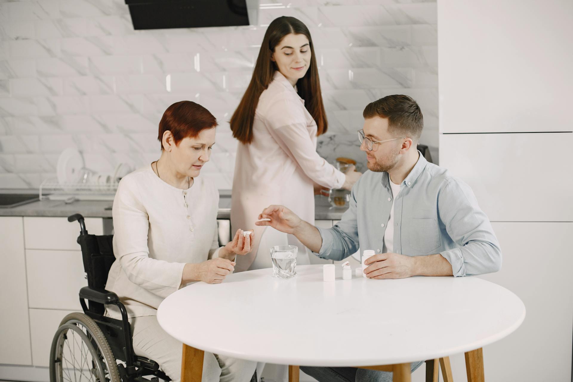 Two carers assisting a female wheelchair user