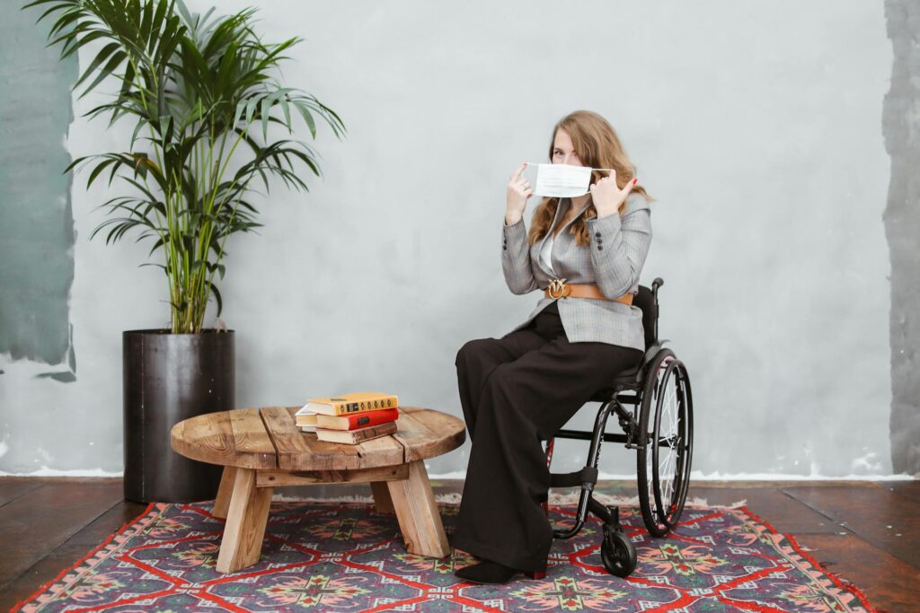 Wheelchair user putting on her mask