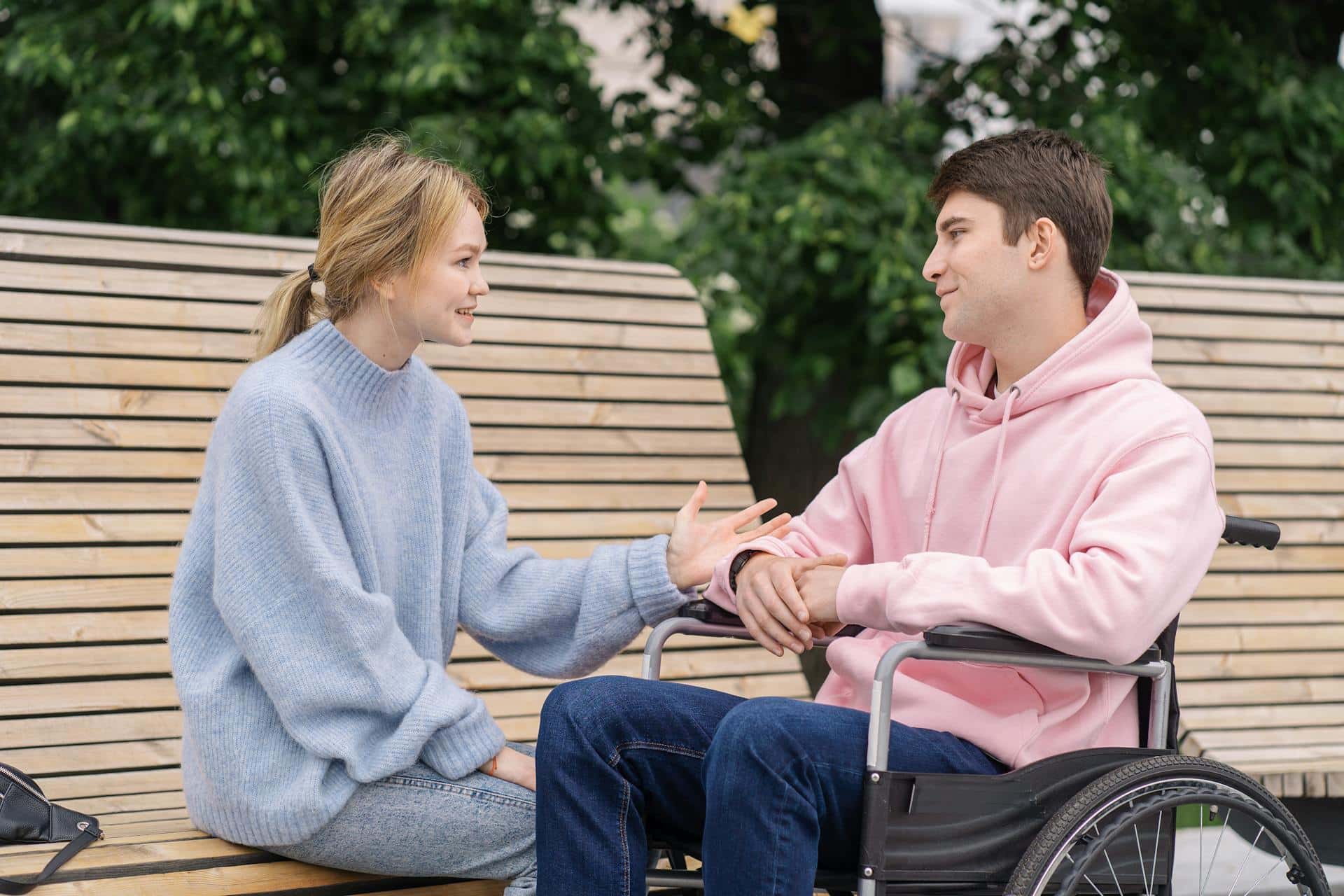 Caregiver in blue assisting client in pink