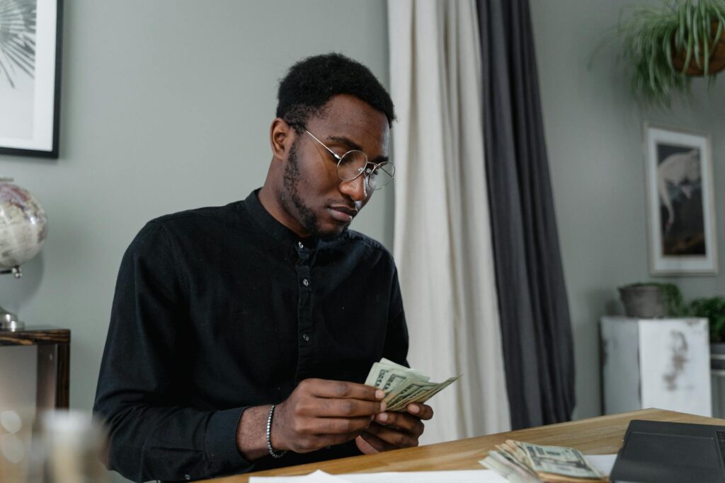 Man counting money bills on the table