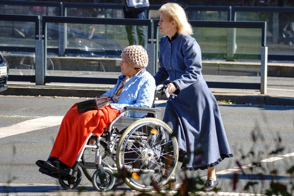 Caregiver pushing the wheelchair of a senior