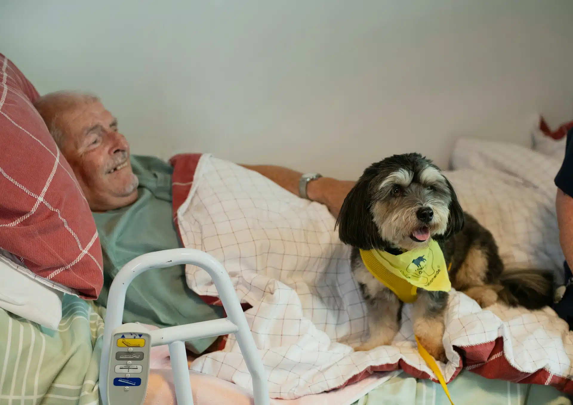 senior patient and dog on a bed