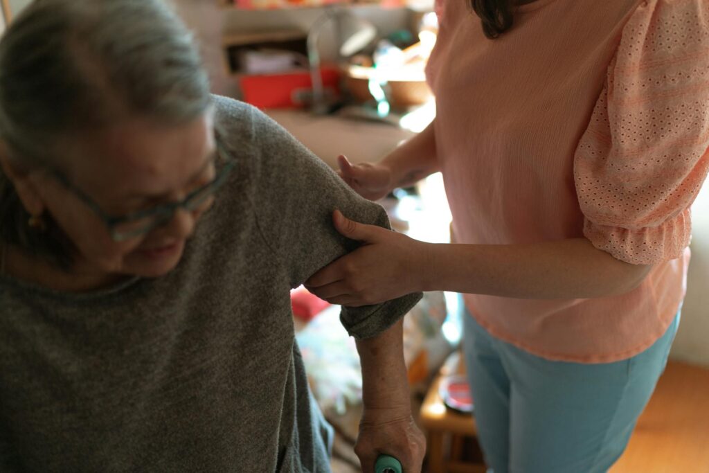 caregiver helping senior stand up