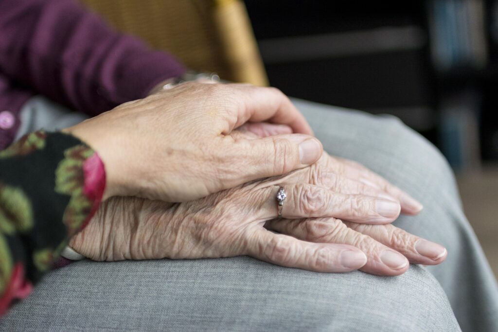 Two senior people hands